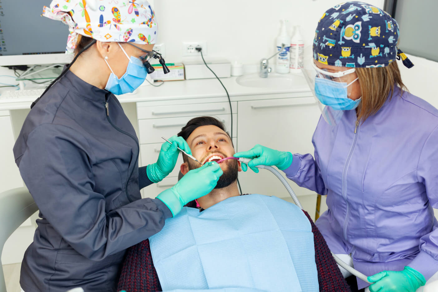 female-dentist-examines-a-man-patient-in-a-dental-2025-03-23-20-28-11-utc